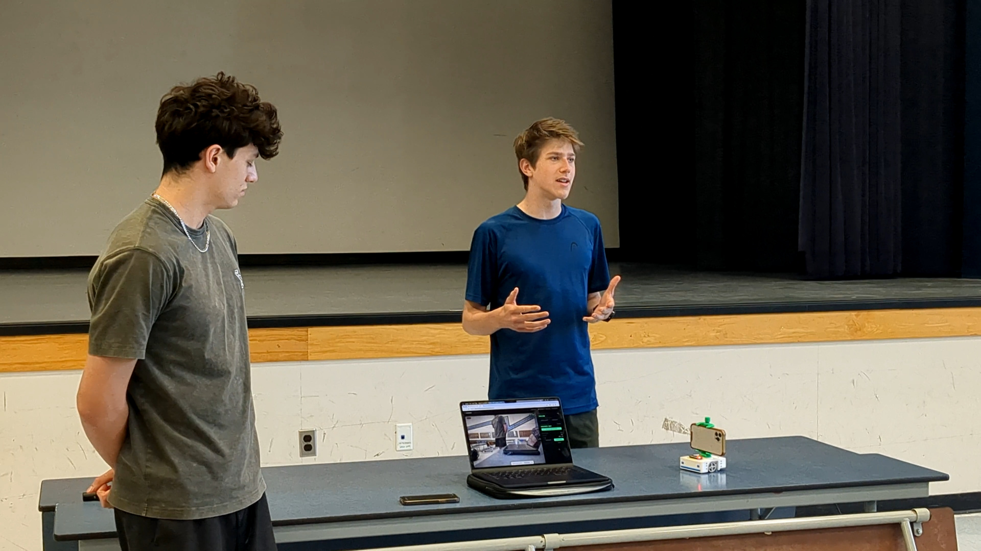 Anthony speaking beside a team presenting a Stackr add-on